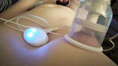 Horny femboy with tied up legs edges themself while having their nipples rubbed by breast cup toy