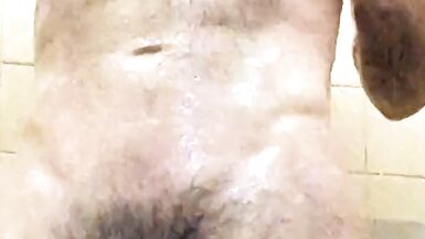 Dad takes a hot shower after a cold hike at the camp shower. - 6 image